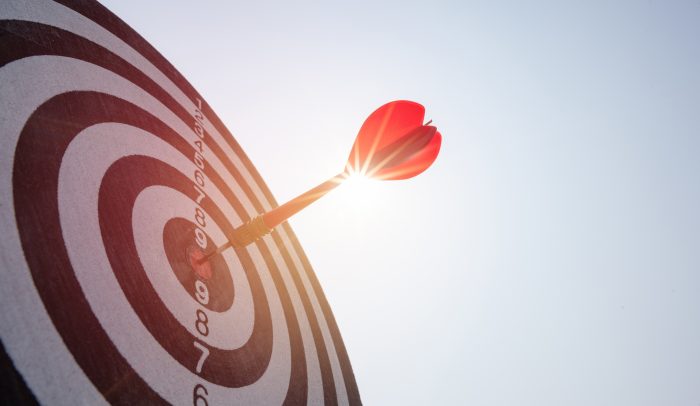A target with a dart in the bullseye position.