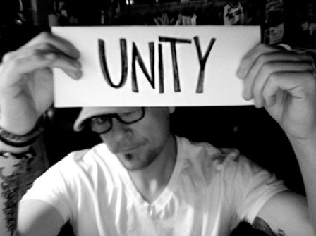 Joe Kalinowski holding up a paper that says Unity.