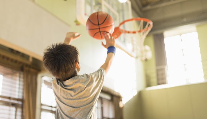 boy shooting a basketball 